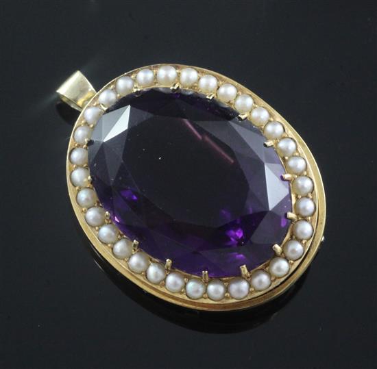 A gold mounted oval cut amethyst pendant brooch, 34mm.